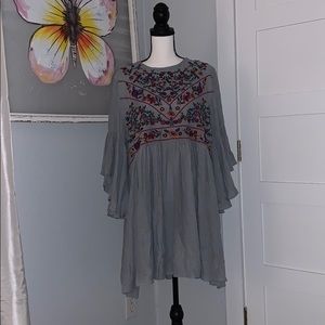 Grey dress with multicolored flower embodiment
